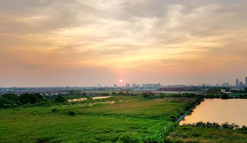 Scenic view of field against sky during sunset