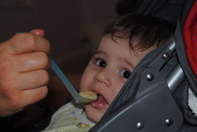 Close-up portrait of cute boy holding camera