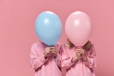 Midsection of woman holding balloons