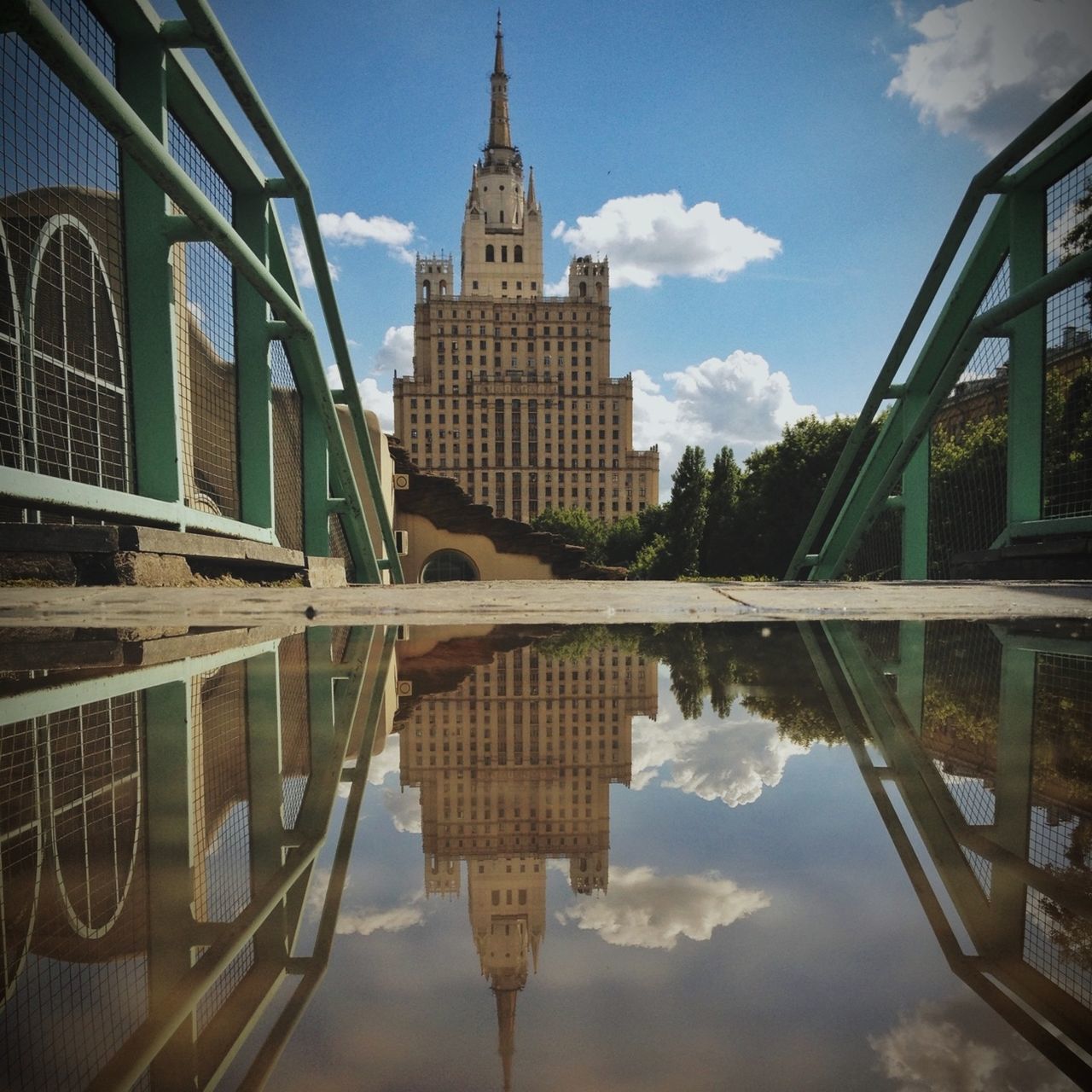 architecture, built structure, building exterior, reflection, water, sky, waterfront, cloud - sky, city, cloud, river, building, standing water, tower, day, canal, lake, outdoors, travel destinations, no people