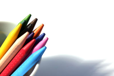 Close-up of colored pencils against white background