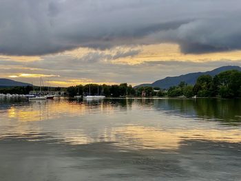 Scenic view of lake against sky during sunset