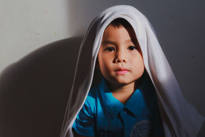 Portrait of boy with towel on head