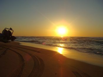 Scenic view of beach against sky during sunset