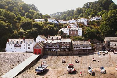 High angle view of boats moored in front of houses during low tide at clovelly