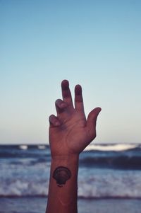 Close-up of human hand on beach