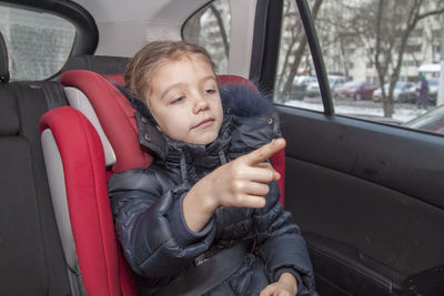 Close-up of girl sitting in car