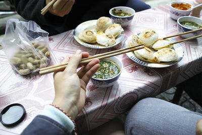 High angle view of woman having food on table