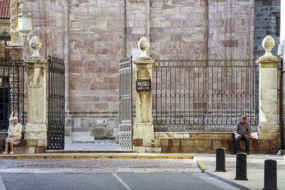 Rear view of man walking in front of building