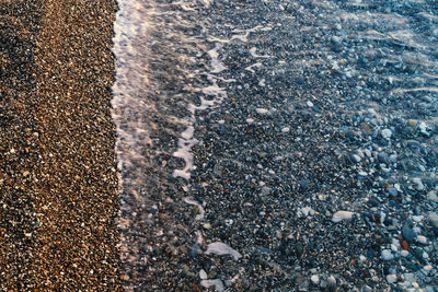 High angle view of stones on wet land