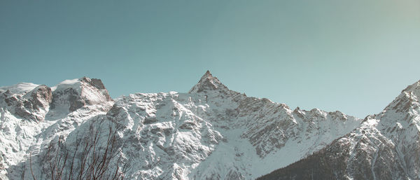 Scenic view of snowcapped mountains against clear sky