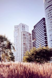 Low angle view of modern buildings against clear sky