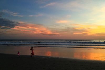 Scenic view of beach against sky during sunset