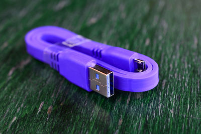 Close-up of purple usb cable on table