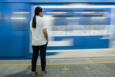 Full length of man standing at railroad station