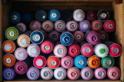 Colorful aerosol cans in cabinet