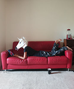 Person on sofa wearing mask using wireless technology