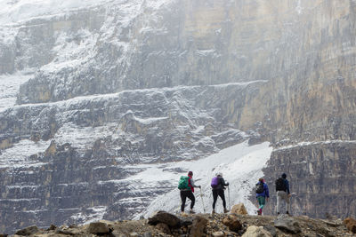 Hiking group going up to the canadian rockies. with the background of the snowy mountain 