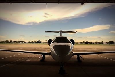 Airplane on road at sunset