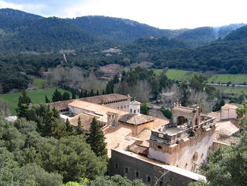 High angle view of trees and buildings against mountains
