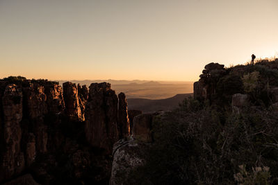 Panoramic view of rock formations against sky during sunset