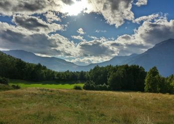 Scenic view of mountains against cloudy sky