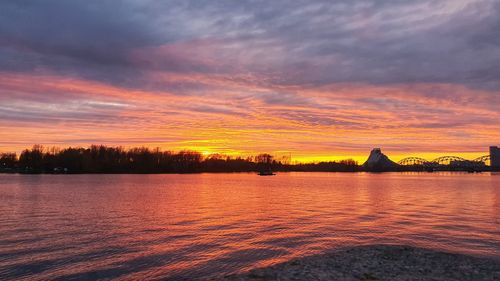 Scenic view of lake against romantic sky at sunset