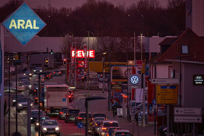 Traffic sign on road in city at night