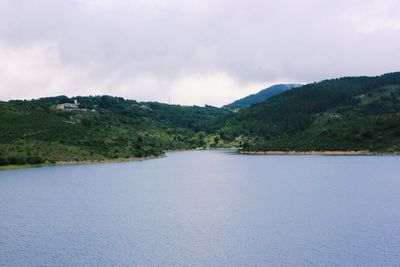 Scenic view of lake and mountains against sky