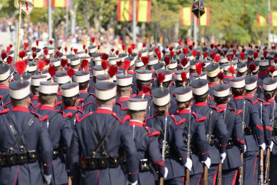 Rear view of soldiers marching outdoors