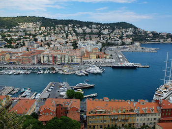 High angle view of townscape by sea against sky