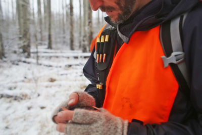 Male hunter checks his gps while hunting in colorado.