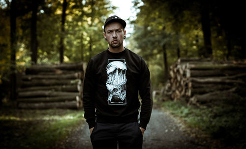 Young man standing in forest