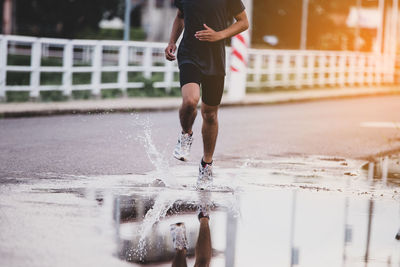 Low section of man running on water