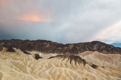 Scenic view of mountain at death valley national park against cloudy sky