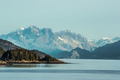 Lake against mountains against clear sky