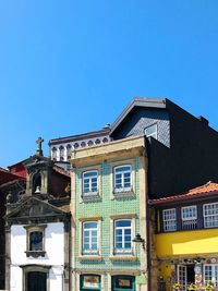 Low angle view of building against clear blue sky