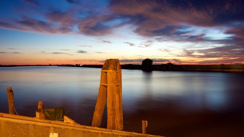 Scenic view of lake against sky during sunset