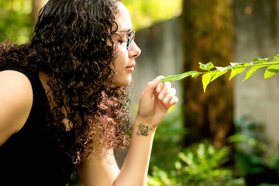 Midsection of woman holding plant