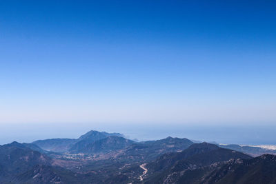 Scenic view of mountains against clear blue sky