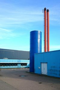 Low angle view of pipe in industry against sky