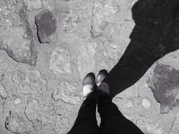 Low section of person standing on tiled floor