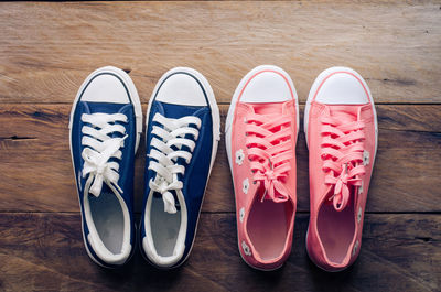 High angle view of blue and pink shoes on hardwood floor