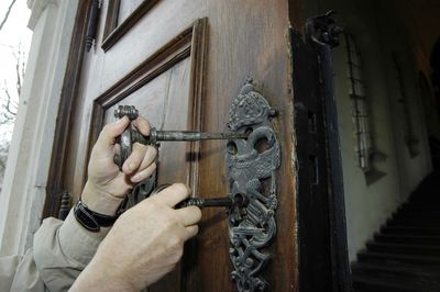 Close-up of man holding door