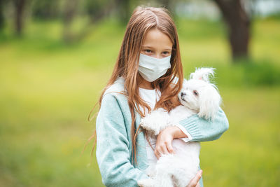 Woman with dog on field