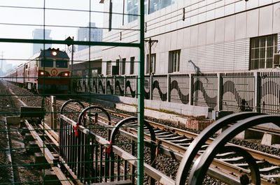 Railroad tracks by buildings in city