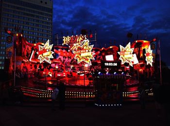 Illuminated ferris wheel at night