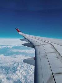 Cropped image of airplane wing against sky