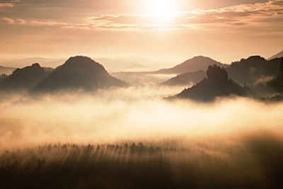 Scenic view of silhouette mountains against sky during sunset