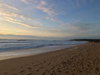 Scenic view of beach against sky during sunset